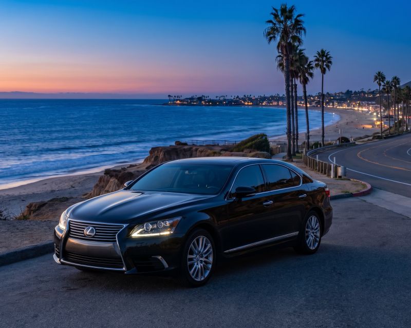 Lexus Sedan at a coastal overlook above the ocean at sunset
