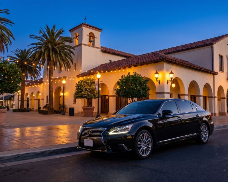 Lexus Sedan parked on a historic street with Mission Revival architecture at blue hour